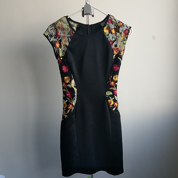 black dress with embroidered flowers